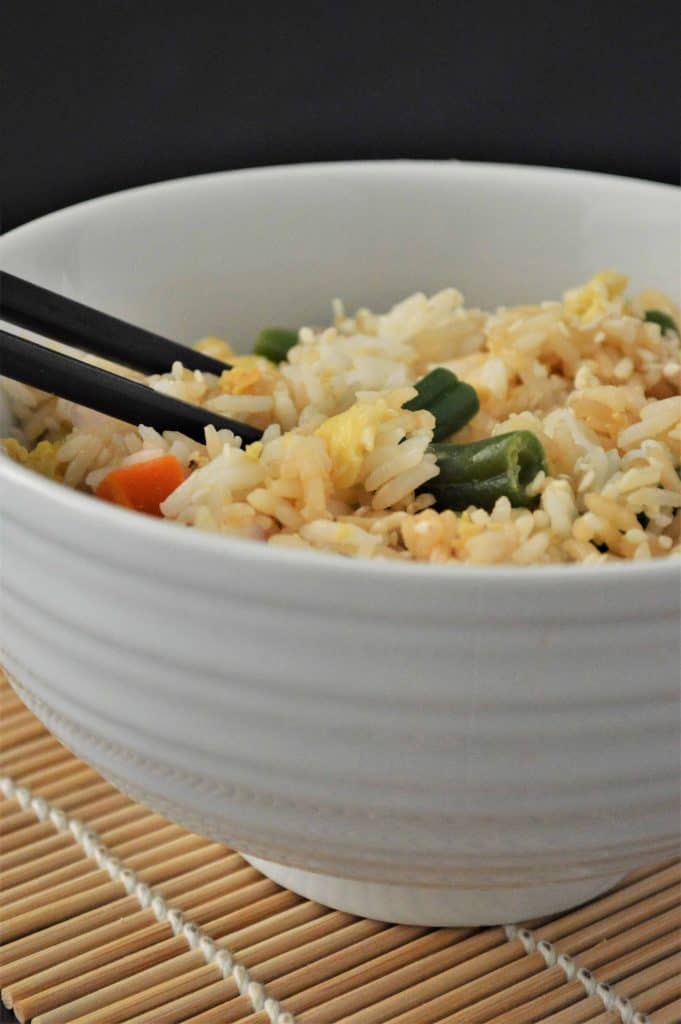 Instant Pot Fried Rice in a white bowl with chopsticks.
