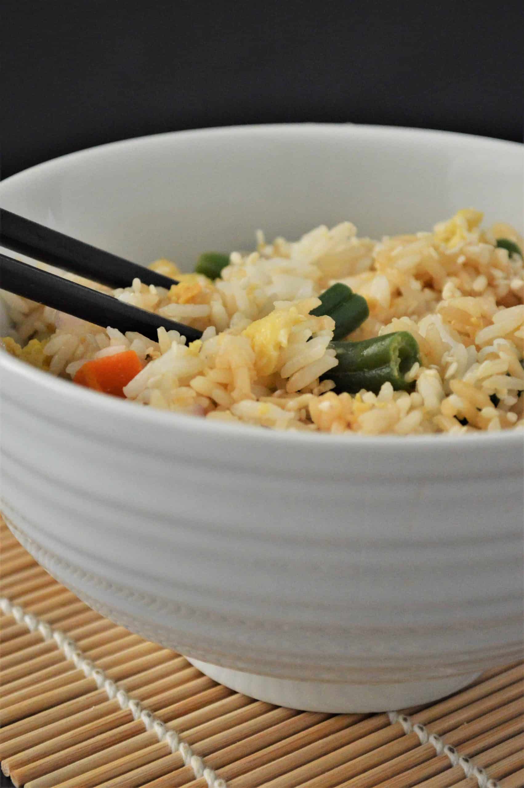 Instant Pot Fried Rice in a white bowl with chopsticks.