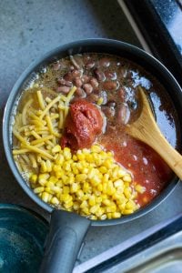 Add broth, macaroni, tomatoes, beans and corn and boil