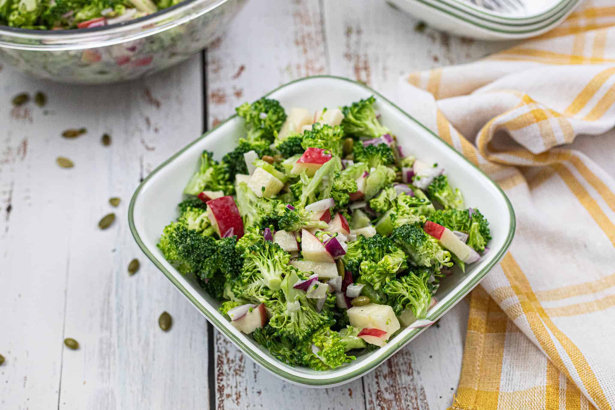 Broccoli Apple Salad in white square serving bowl.
