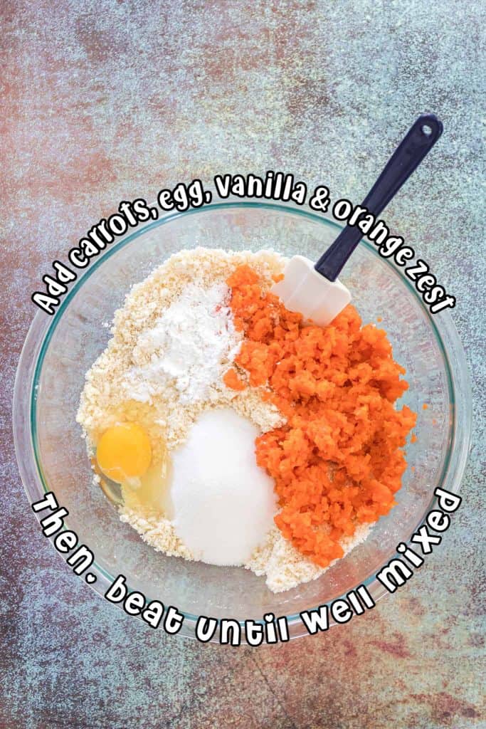 Mashed carrots, flour, sugar and eggs in a large glass bowl.