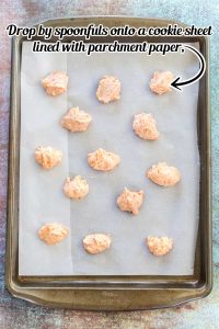 Carrot Cookie dough dropped onto baking sheet lined with parchment paper.