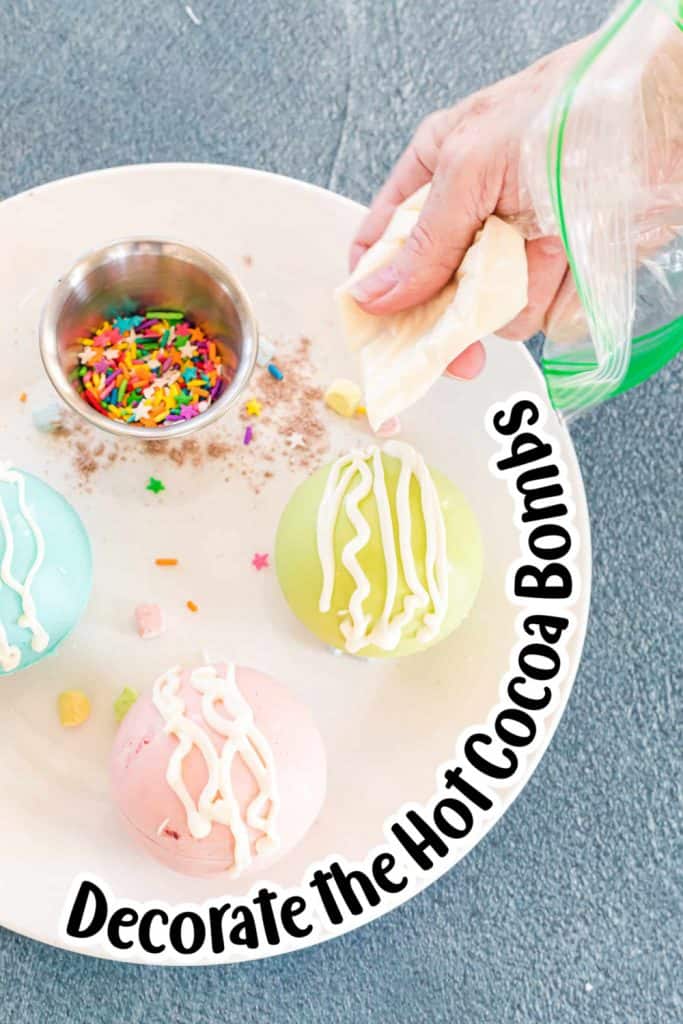 Decorating the hot cocoa bombs with icing.