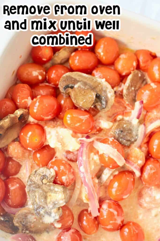 Cherry tomatoes, mushrooms and feta cheese in a baking dish.