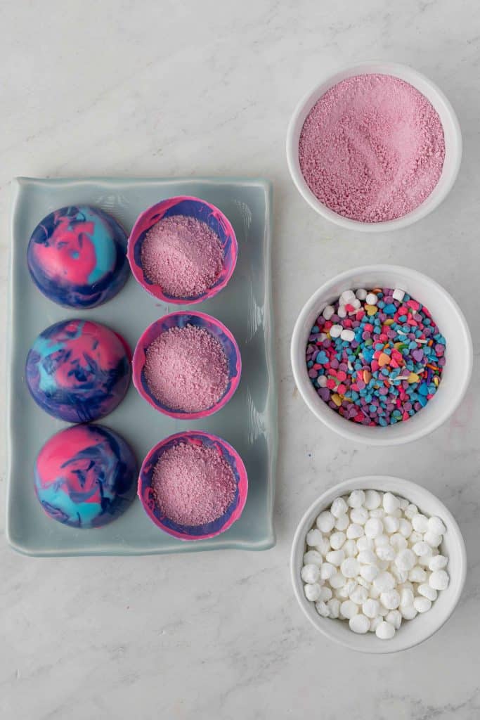 Molds with strawberry drink mix in them.