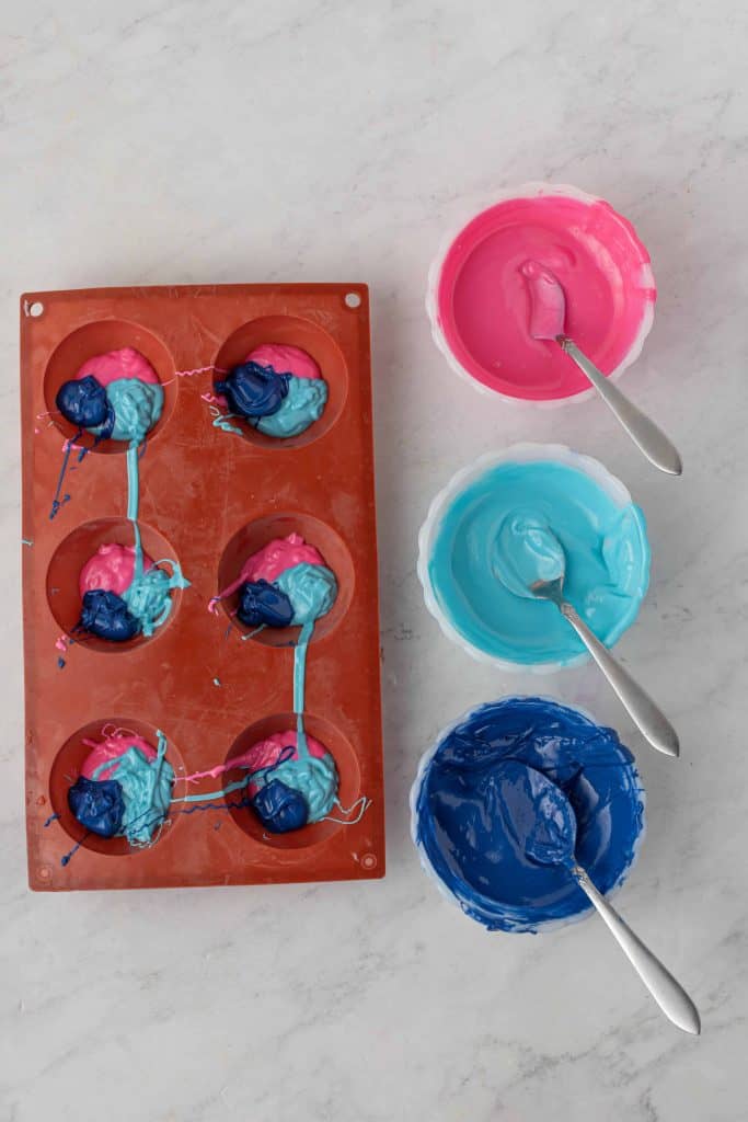 Multi colored candy melts in silicone mold.