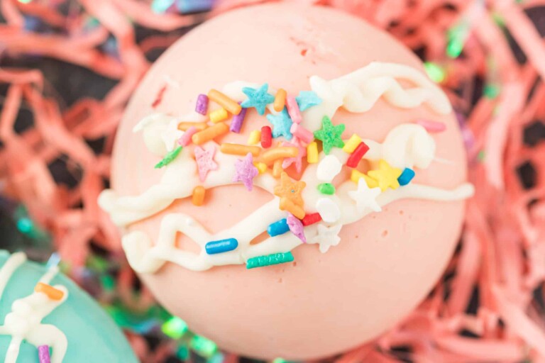 Closeup photo of pink hot cocoa bomb with sprinkles.