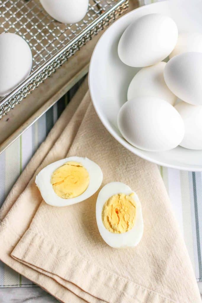 Hard boiled egg cut in half on a napkin.