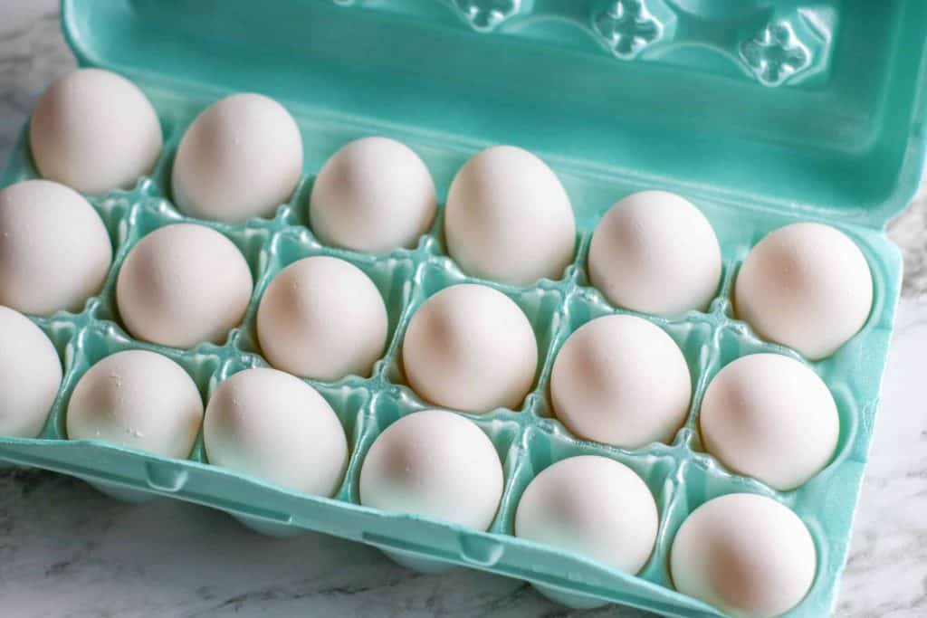 Eggs in a green styrofoam carton.