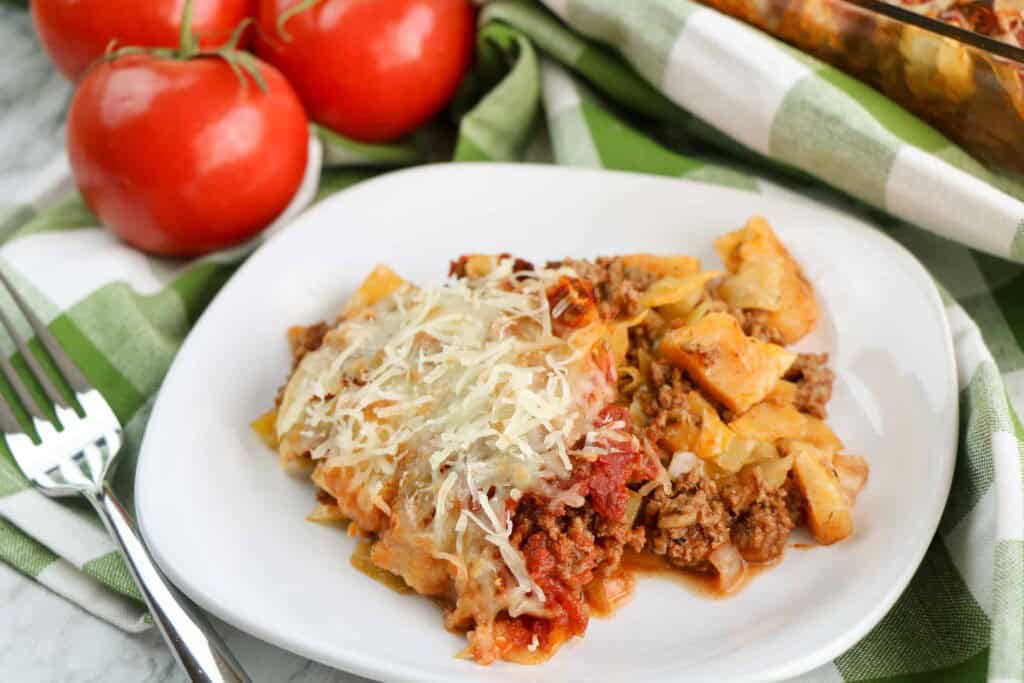 Closeup of cabbage casserole on a white plate.