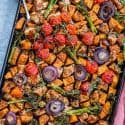 Overhead view of sheet pan chicken with vegetables.