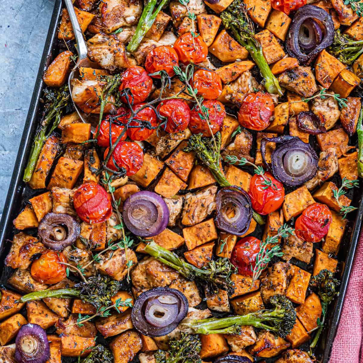 Overhead view of sheet pan chicken with vegetables.