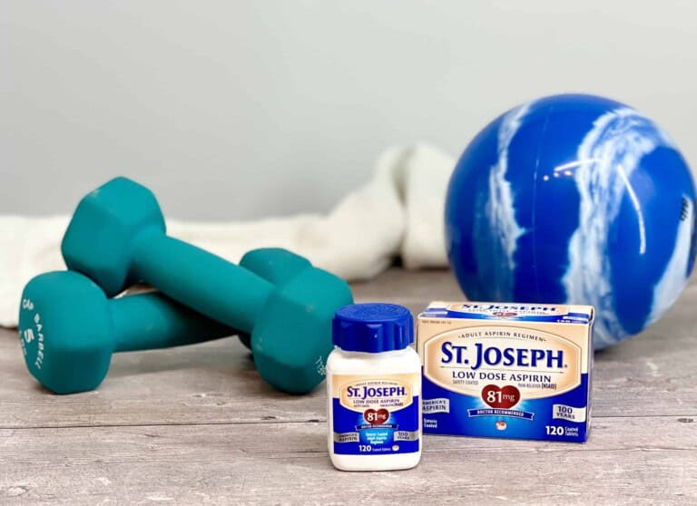 St. Josheph's Aspirinon a wood floor with weights and a medicine ball in the background.