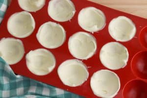 White chocolate in half of red silicone mold.