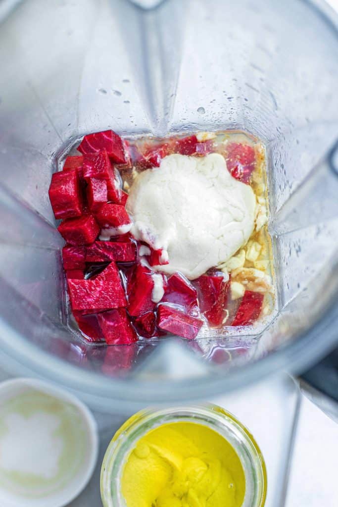 Beets, tahini and olive oil in a blender.