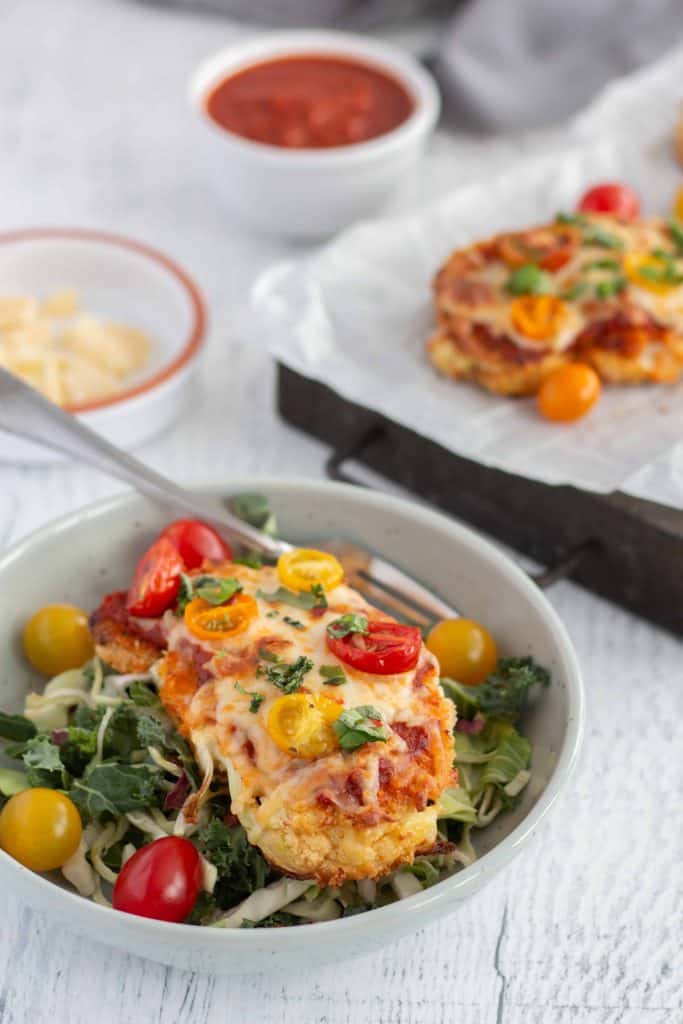 Cauliflower Parmesan on a bed of greens.