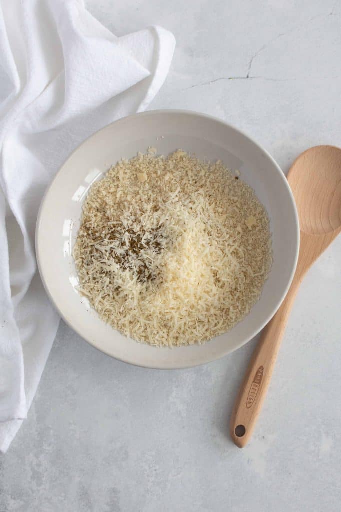 Panko breadcrumbs, cheese and spices in a bowl.
