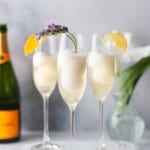 Headon shot of 3 flutes filled with champagne punch.