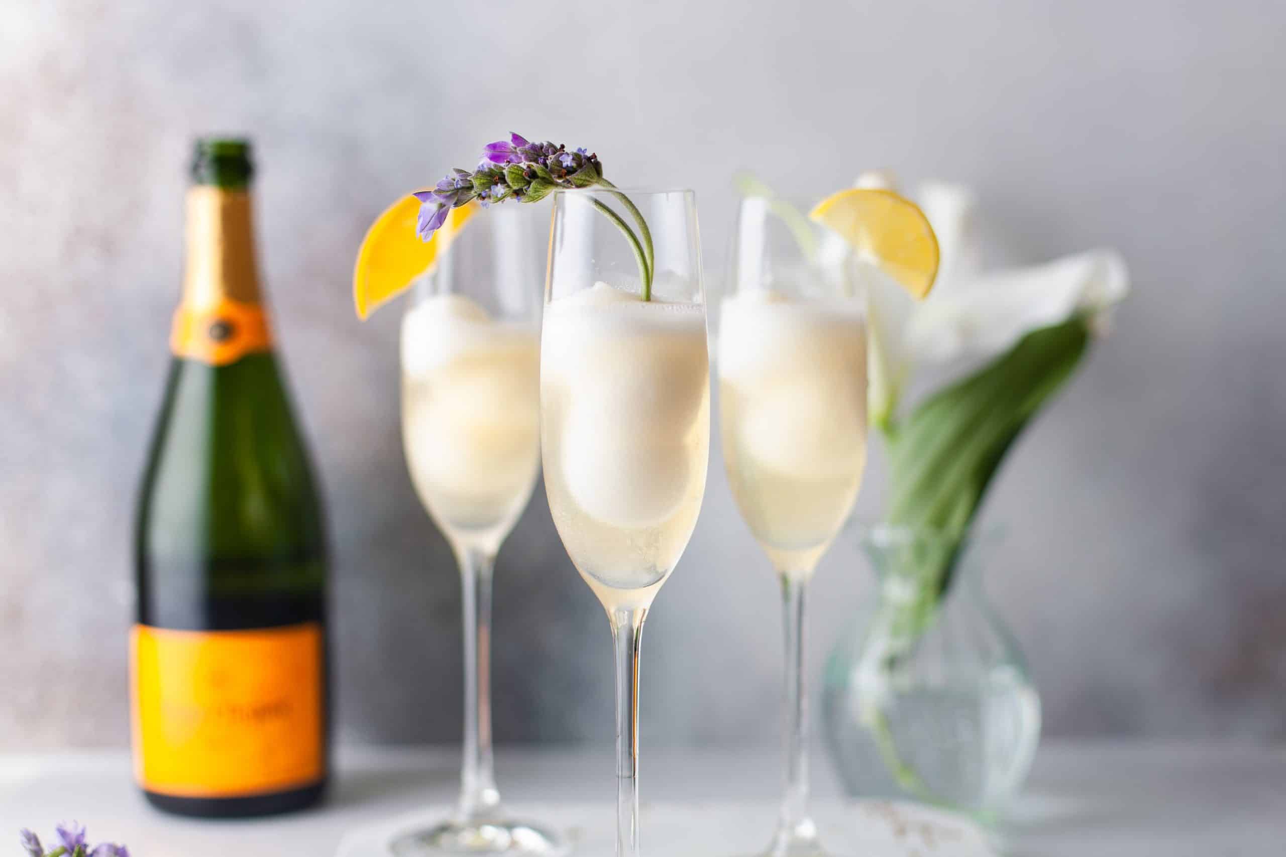 Headon shot of 3 flutes filled with champagne punch.