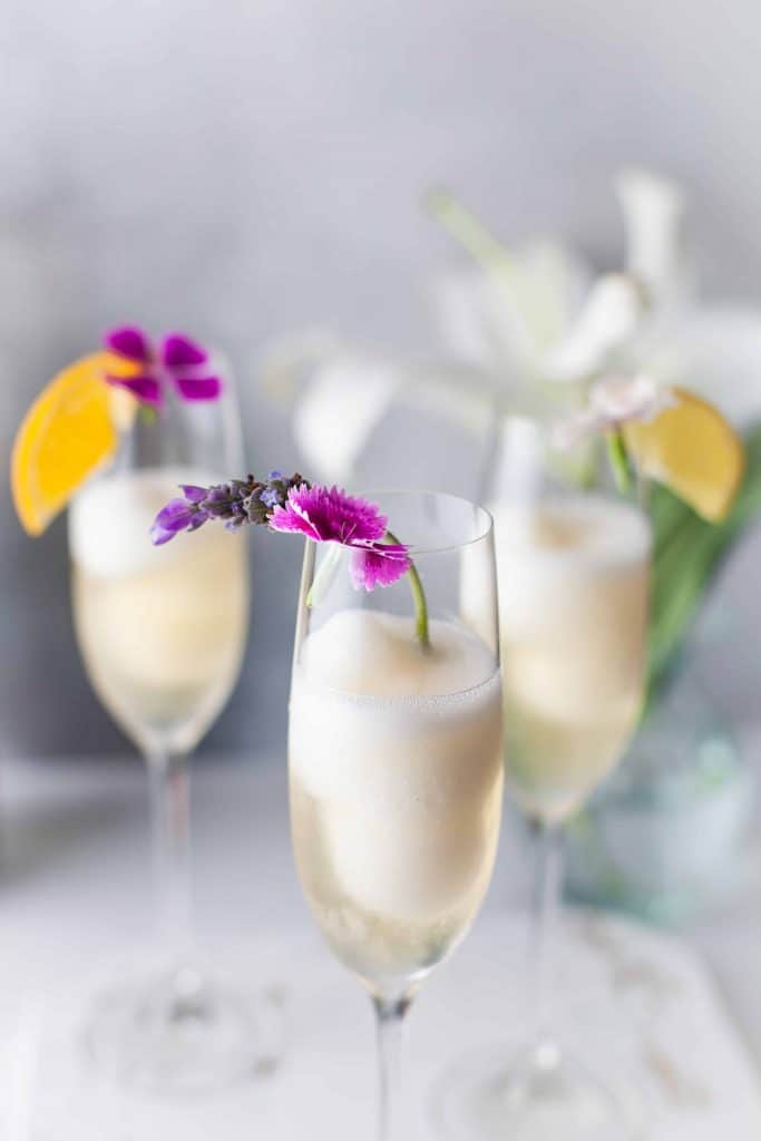Sparkling wine in flutes with flowers