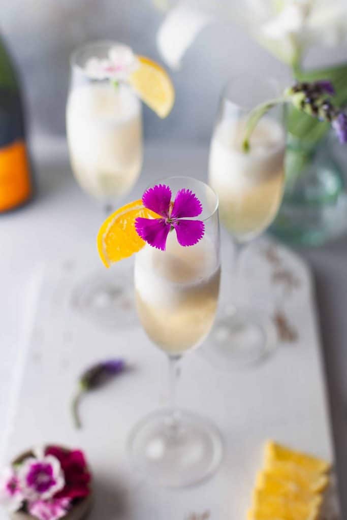 closeup of beverage with an edible flower in it.