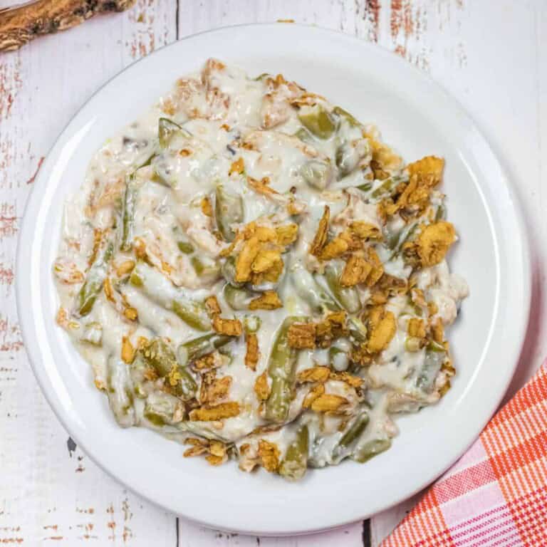 Overhead view of green bean casserole on a white plate.