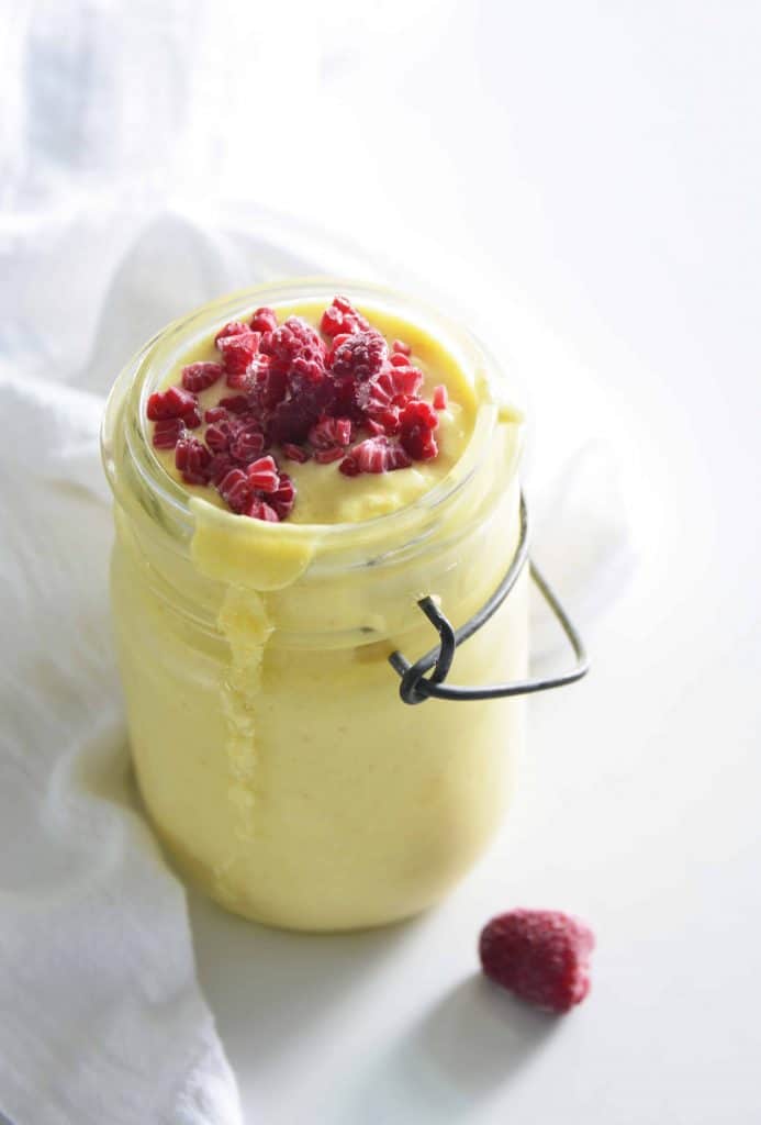 Tropical smoothie in a glass Mason jar.
