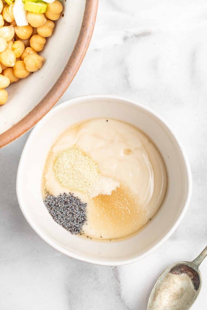 Salad dressing ingredients in a small white bowl.