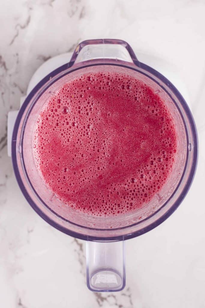 Blended fruit smoothie in a blender.