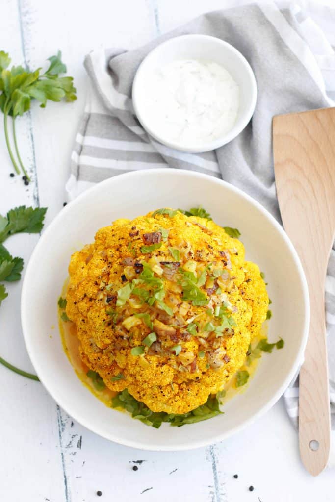 Whole Roasted Cauliflower with Curry and Yogurt Sauce.