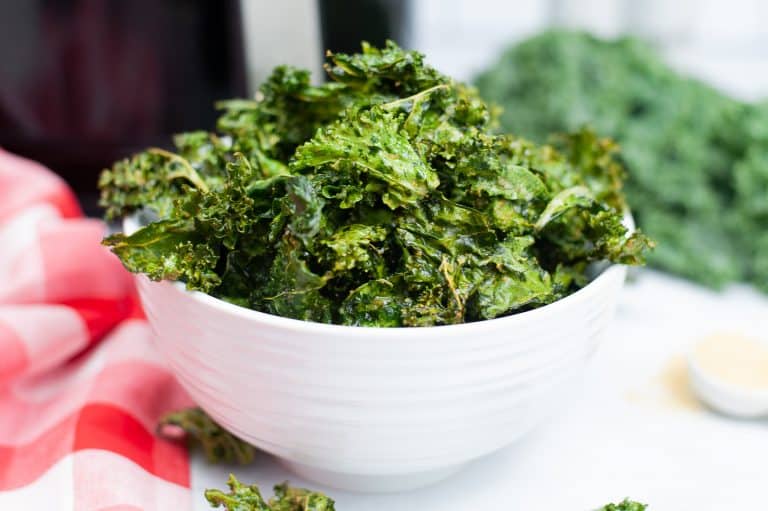 White bowl with air fryer kale chip.