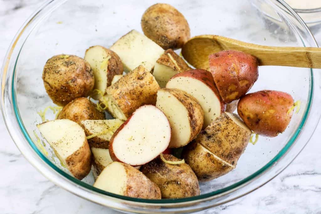 Red and yellow potatoes in a glass bowl.