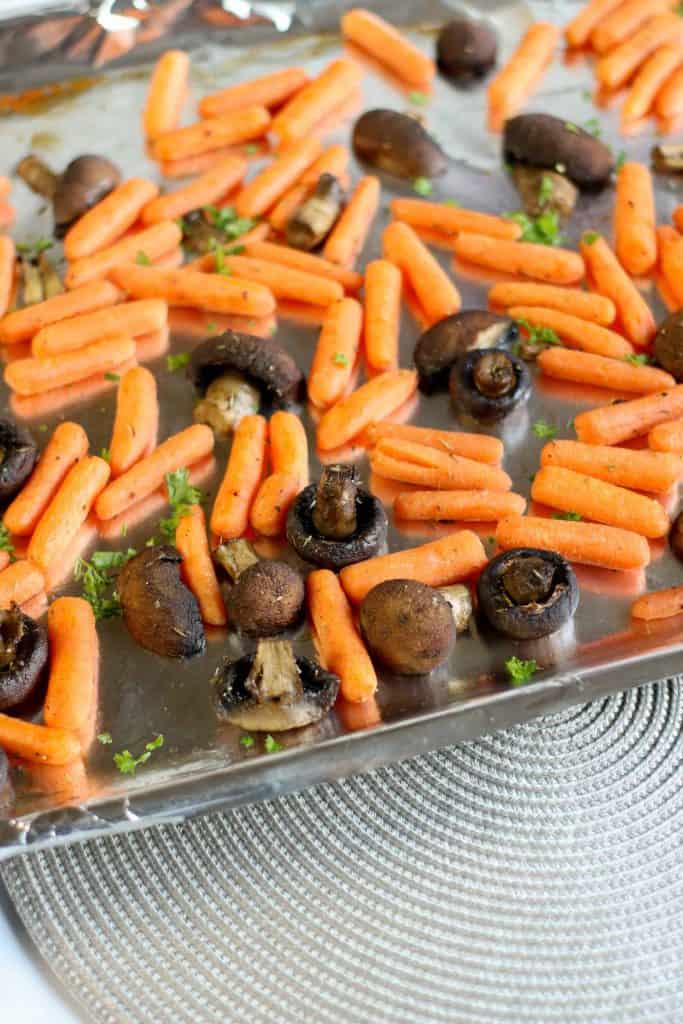 Oven Roasted Carrots and Mushrooms on a foil lined baking sheet.