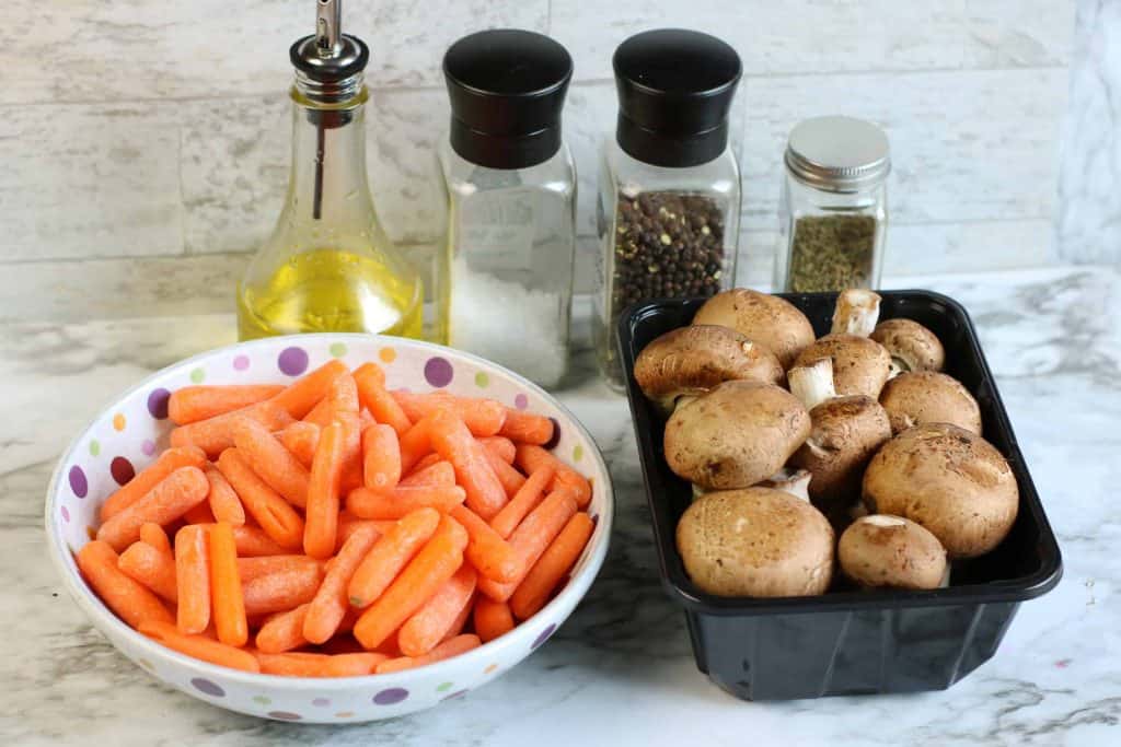 A bowl of carrots, container of mushrooms, olive oil, salt, pepper and thyme.