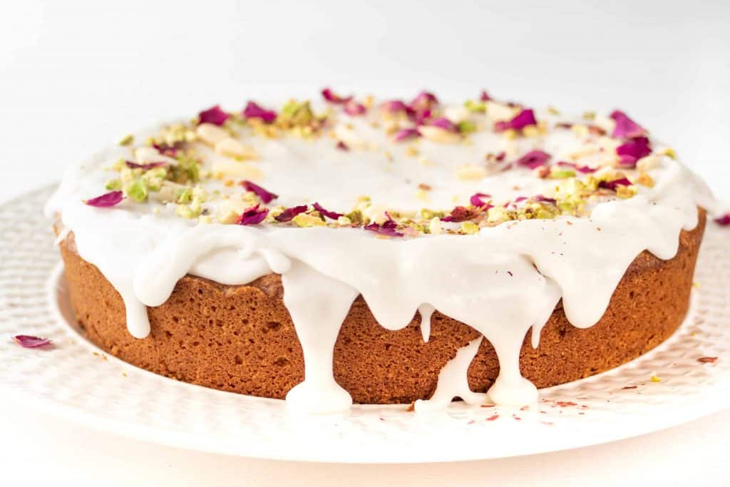Side view of Persian Love Cake with glaze dripping over edge of cake.