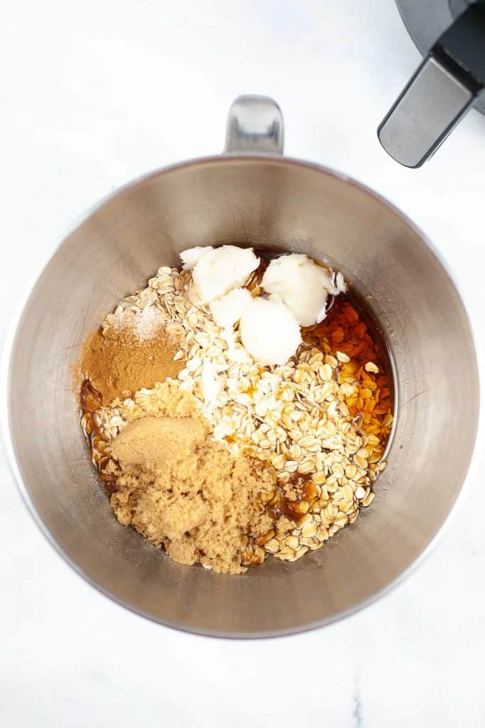 In a large bowl, add in the old fashioned oats, maple syrup, coconut oil, light brown sugar, salt, cinnamon and vanilla.