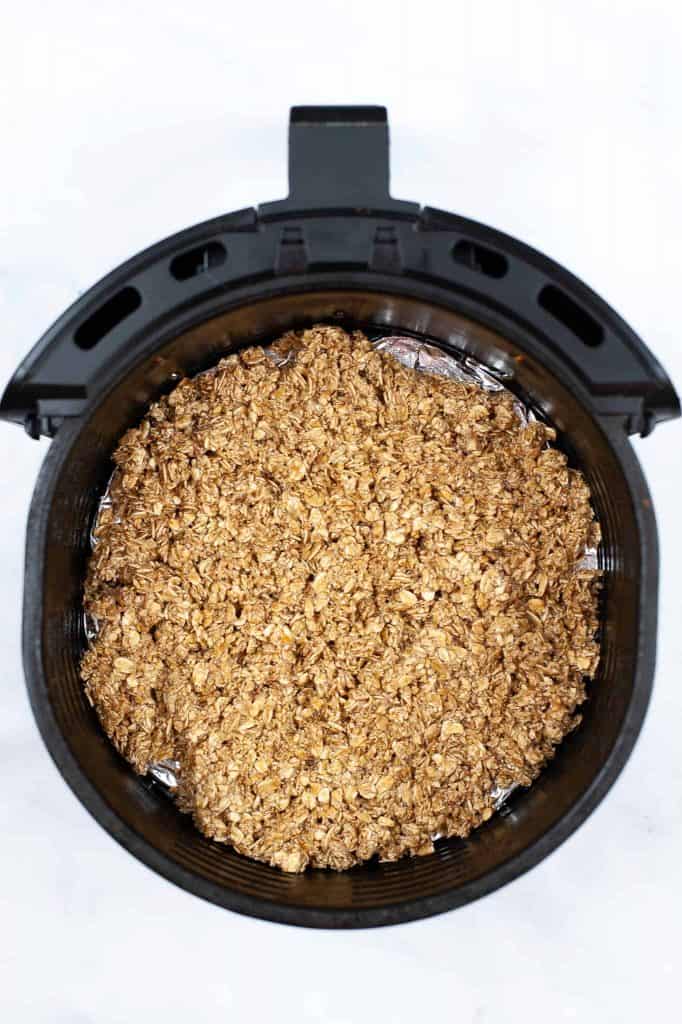 Oatmeal mixture in bottom of air fryer basket.