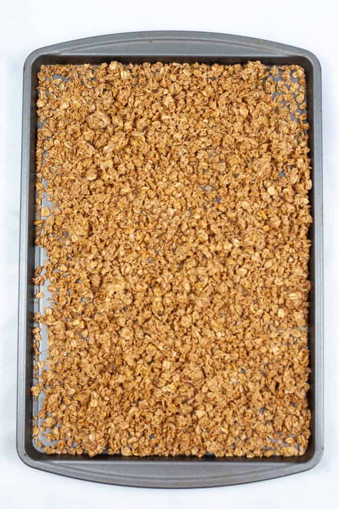 Granola spread out on a sheet pan.
