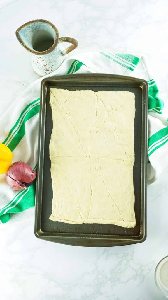 Baked Crescent Roll dough on a sheet pan.