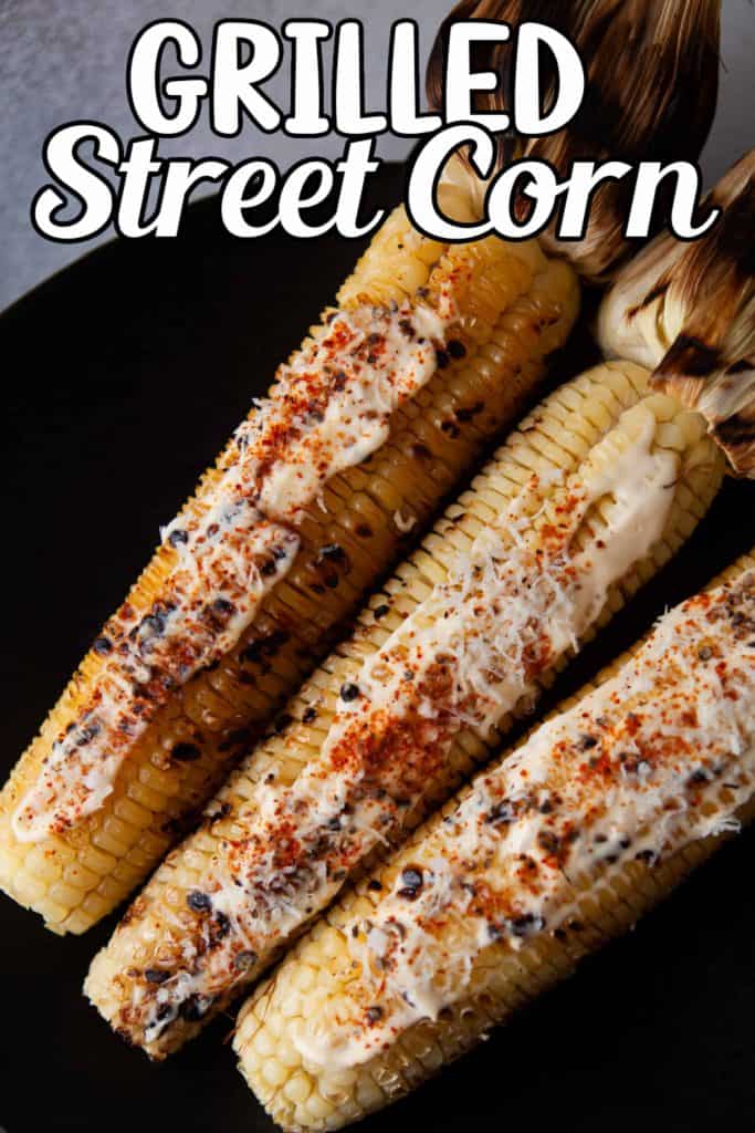 Grilled Street Corn on a black plate.