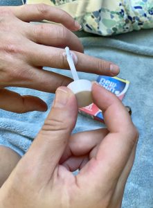 Applying Liquid Bandage to knuckle on hand.