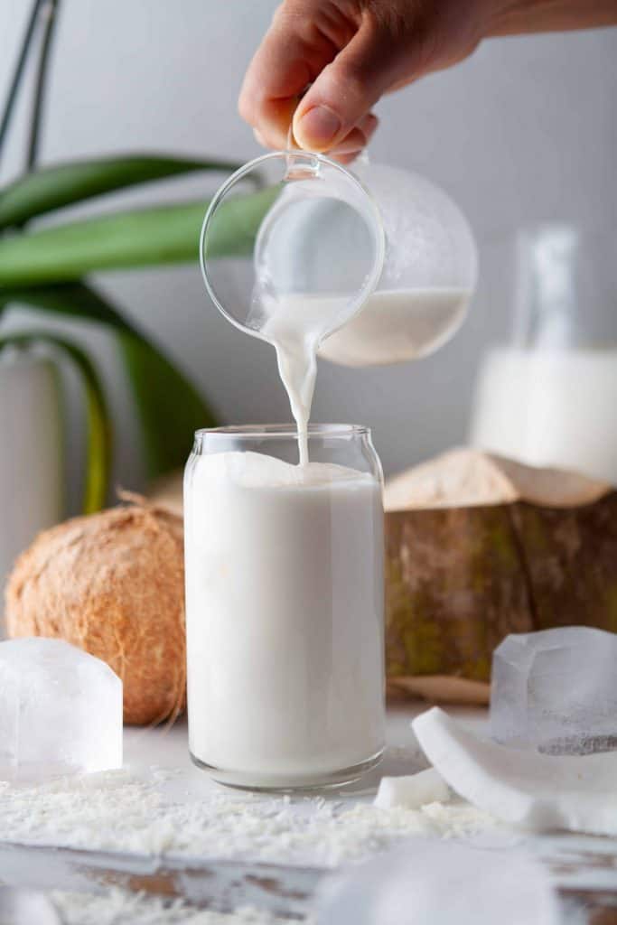 Pouring tropical drink into a glass.