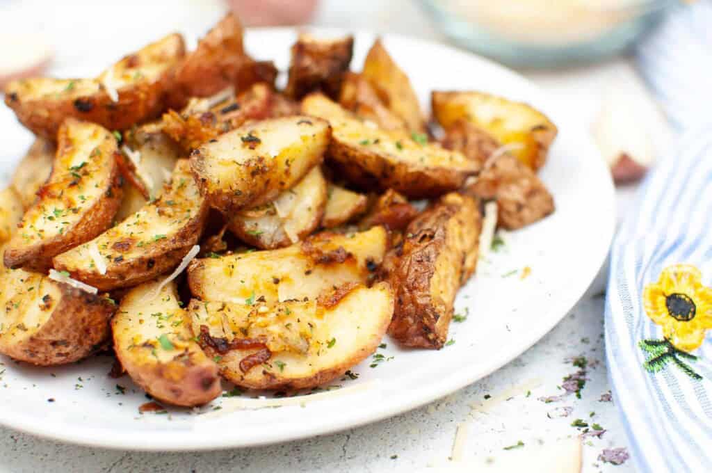 Roasted potato on a white plate.
