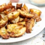 Roasted potato on a white plate.