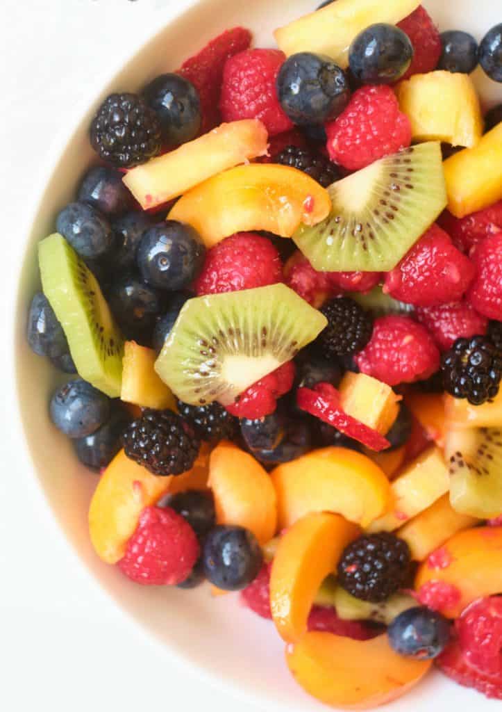 Kiwi, fresh berries and apricot in a large serving bowl.