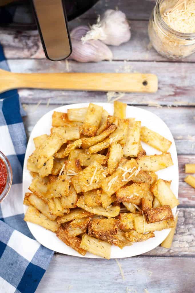 Overhead view of pasta chips on a white plate.