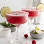 2 frozen drinks with fruit side by side.