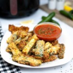 Plate of zucchini fries with marinara sauce.
