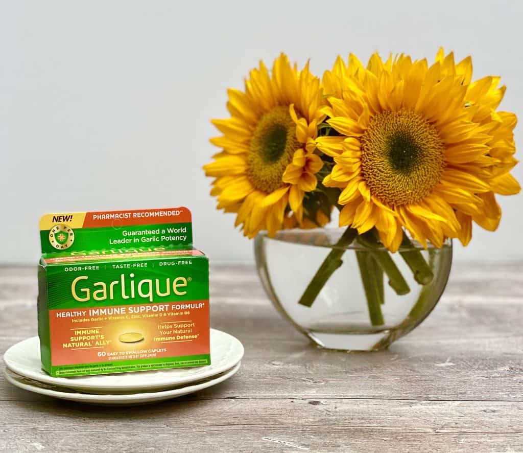 Garlique supplement on 2 white plates with sunflowers beside it.