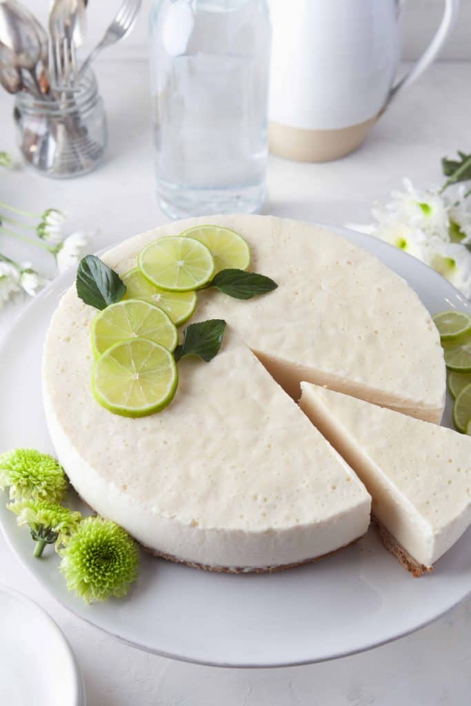 Frozen lime pie with a slice being removed.